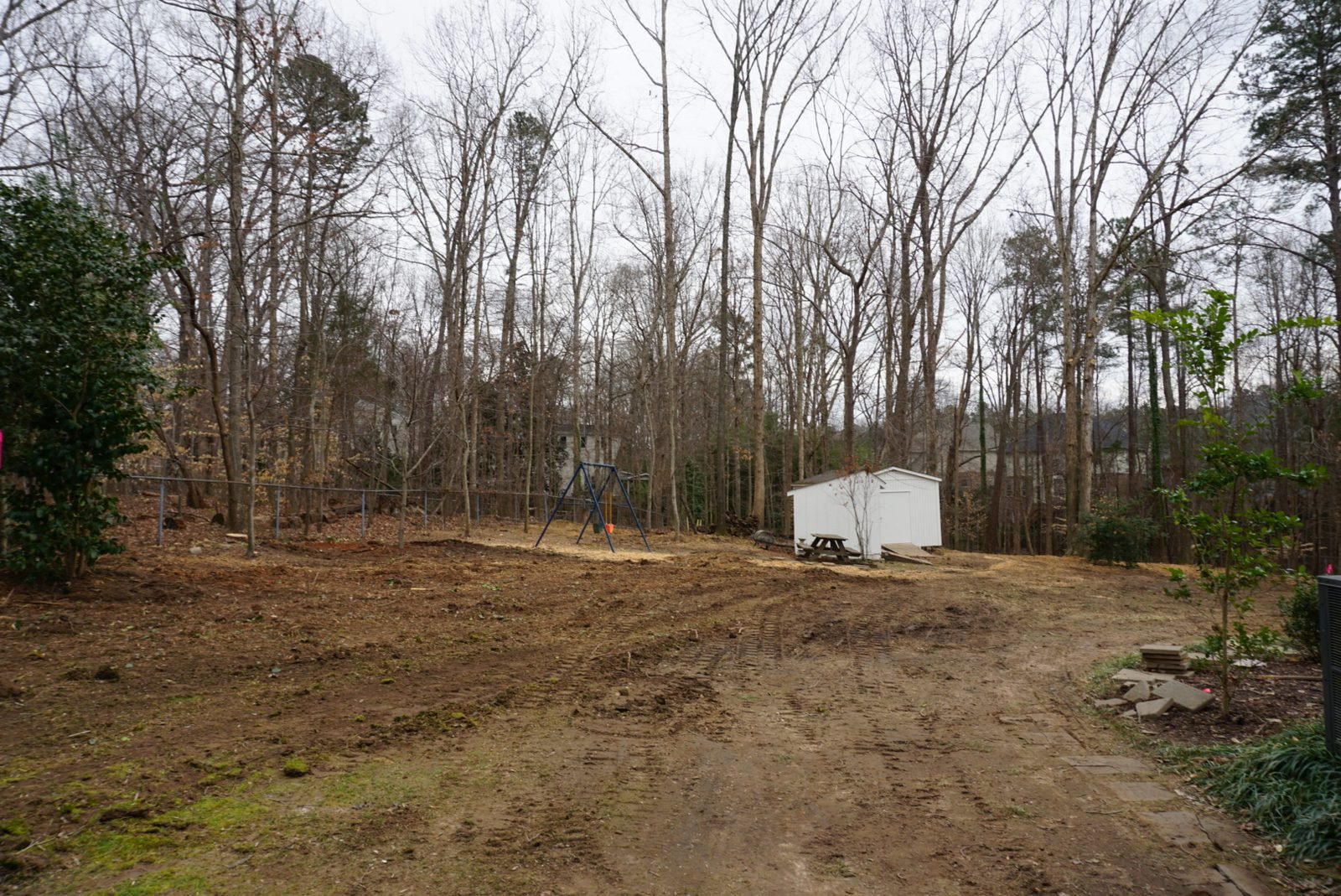 Tidy restored backyard with shed and swing set